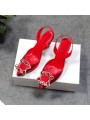 Red satin slingback pumps with stiletto heels, featuring a pointed toe and an elasticated back strap for elegant comfort.