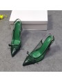 Green leather slingback pumps with stiletto heels, featuring a pointed toe with a bow and a gold-tone metal buckle