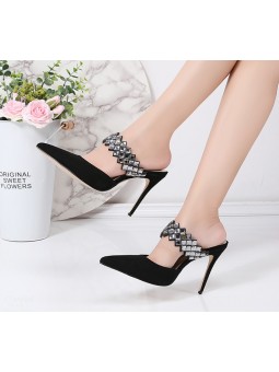 Elegant black suede high-heeled sandals with a strap adorned with rhinestones for a glamorous touch.