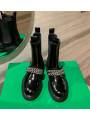 Black patent leather Chelsea boots with double chains