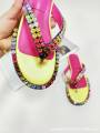 Women's multicolored flip-flops adorned with sparkling crystals, featuring a flat sole and genuine leather insole