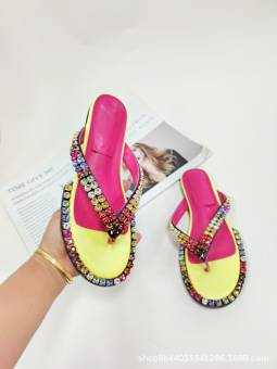 Women's multicolored flip-flops adorned with sparkling crystals, featuring a flat sole and genuine leather insole