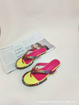 Women's multicolored flip-flops adorned with sparkling crystals, featuring a flat sole and genuine leather insole