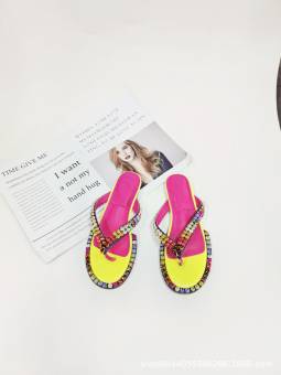 Women's multicolored flip-flops adorned with sparkling crystals, featuring a flat sole and genuine leather insole