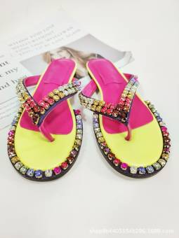 Women's multicolored flip-flops adorned with sparkling crystals, featuring a flat sole and genuine leather insole