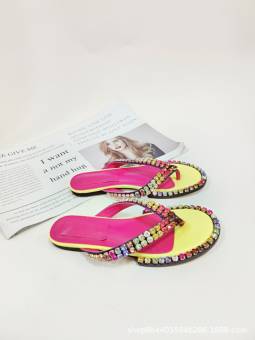 Women's multicolored flip-flops adorned with sparkling crystals, featuring a flat sole and genuine leather insole