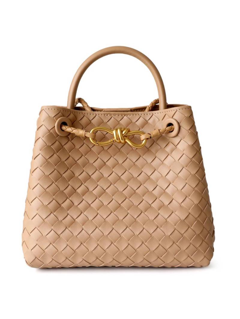 Women's woven leather shoulder bag in nude color with a gold logo.