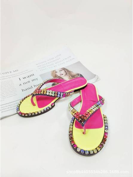 Women's multicolored flip-flops adorned with sparkling crystals, featuring a flat sole and genuine leather insole