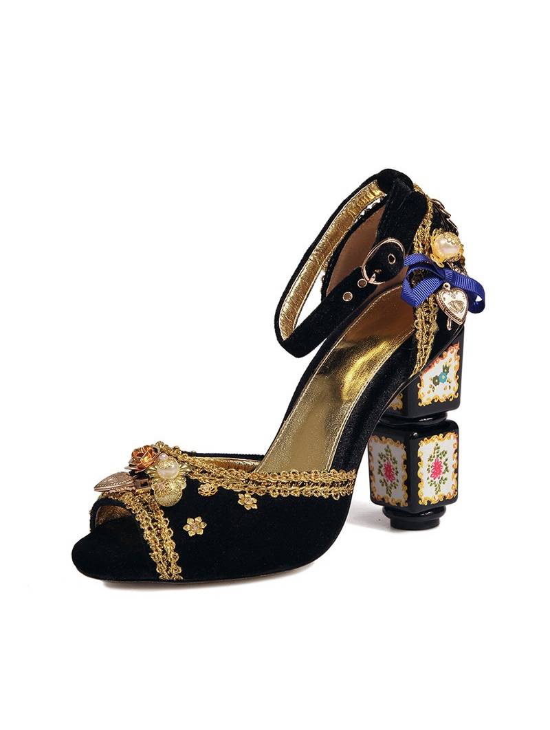 Black velvet sandals with a high block heel, featuring strap closure with a buckle. Gold leather insole