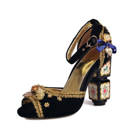 Black velvet sandals with a high block heel, featuring strap closure with a buckle. Gold leather insole